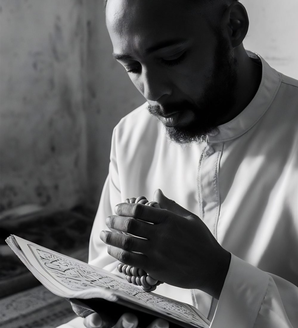 muslim-man-reading-from-quran-holding-praying-beads